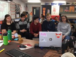 Tenth grade students ask David Gomberg questions via video conference in the classroom.